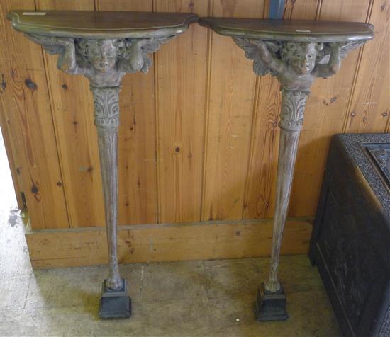 Pair cherub brackets on a stand